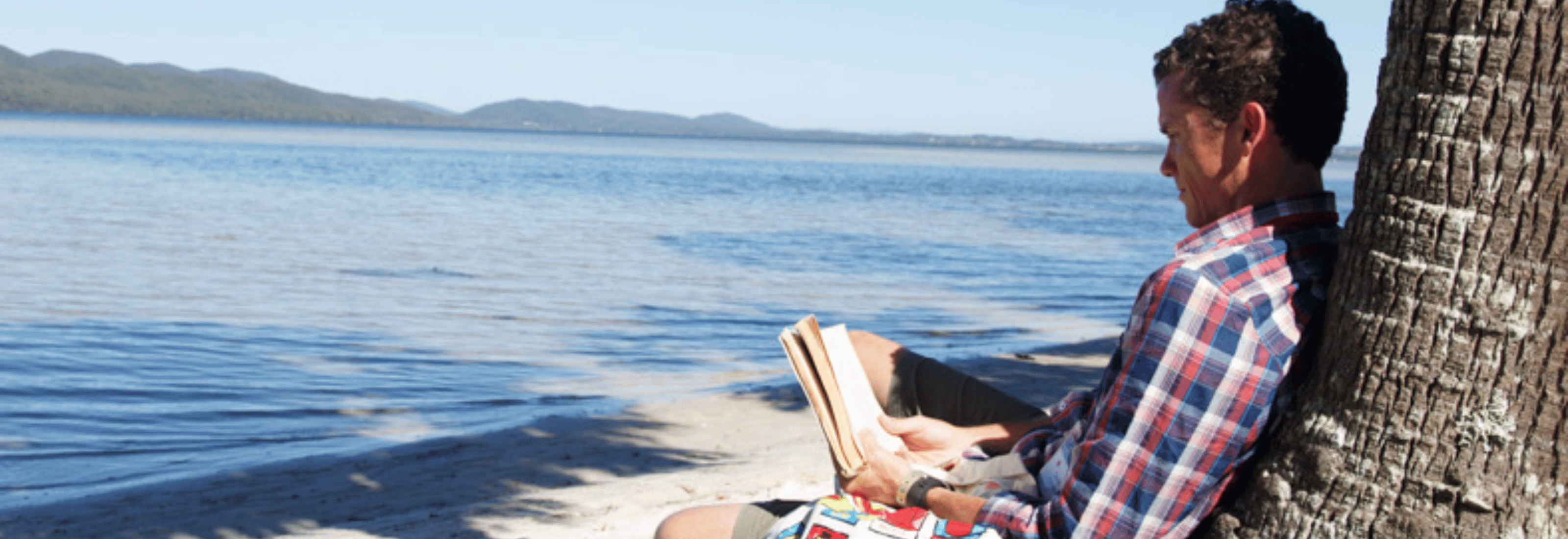 Man reading at Myall Lakes retreat