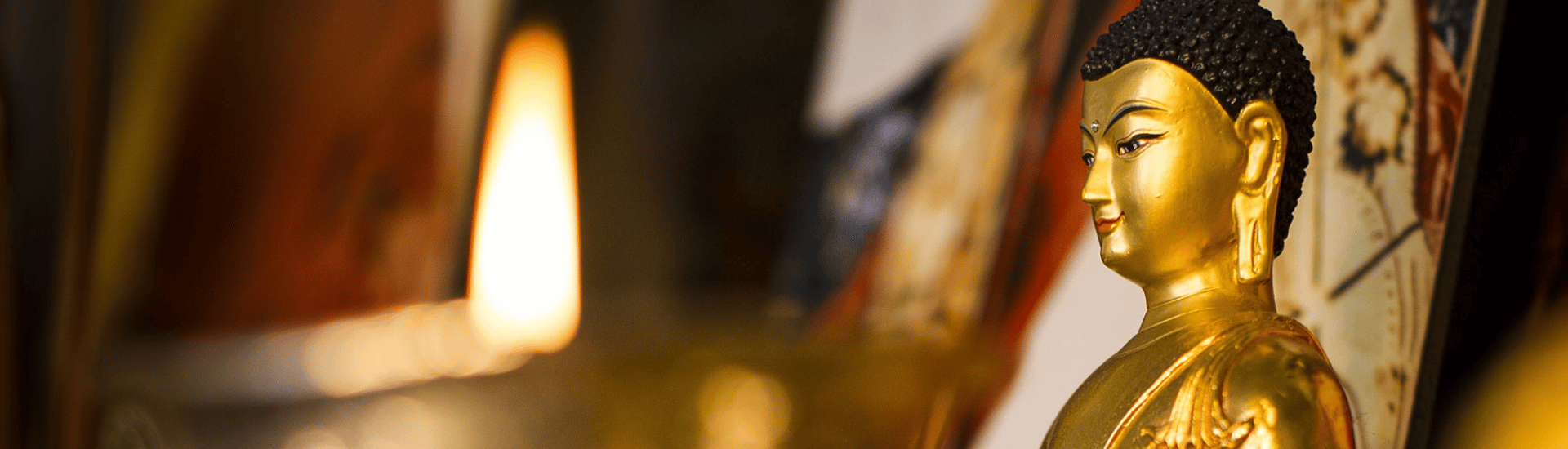 Candle and small Buddha statue